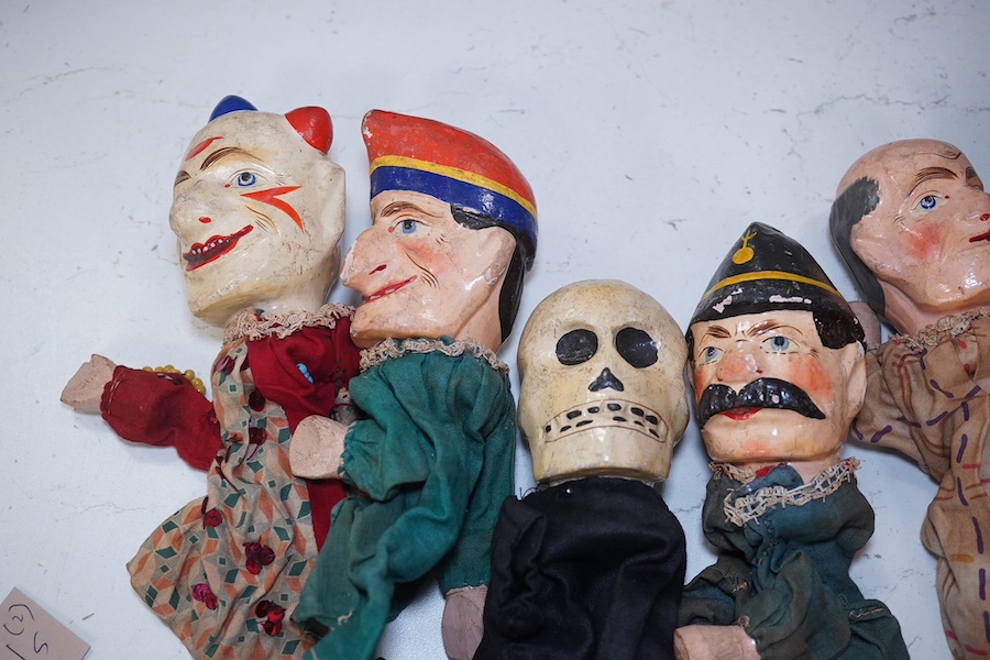 Eight early 20th century puppets, comprising of carved wooden heads, lower legs and feet, and held together by fabric clothes, characters include the devil, a skeleton, Austrian soldier, a clown, Mr. Punch, etc. approx 3